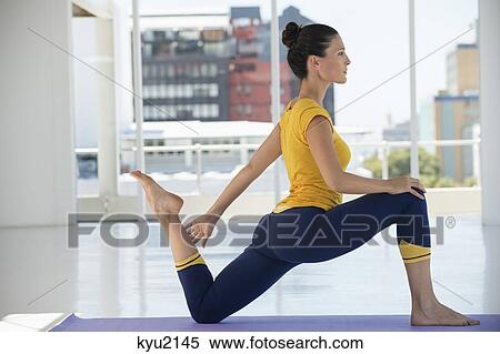 Woman exercising on exercise mat in a gym View Large Photo Image Stock Photography - Woman exercising on exercise mat in a gym. Fotosearch