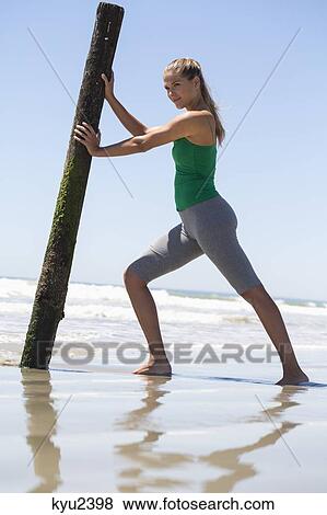 Woman exercising on the beach View Large Photo Image Stock Photo - Woman exercising on the beach. Fotosearch