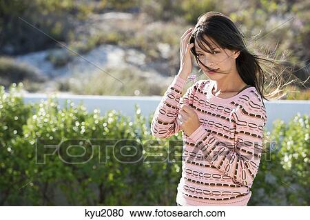Woman holding a flower in vegetation View Large Photo Image Stock Image - Woman holding a flower in vegetation. Fotosearch