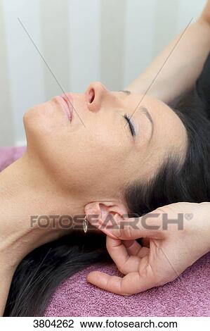 Woman in a beauty parlour. Ear massage View Large Photo Image Stock Image - Woman in a beauty parlour. Ear massage. Fotosearch