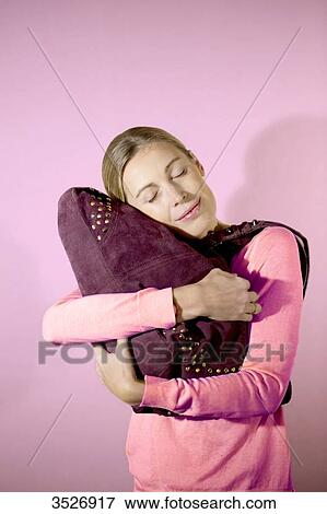 Woman loving her bag View Large Photo Image Stock Photo - Woman loving her bag. Fotosearch