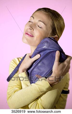 Woman loving her bag View Large Photo Image Stock Photo - Woman loving her bag. Fotosearch