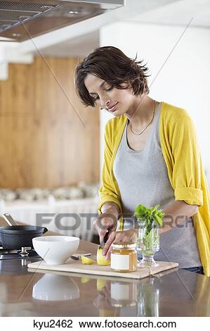 Woman preparing herbal tea in the kitchen View Large Photo Image Stock Image - Woman preparing herbal tea in the kitchen. Fotosearch