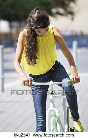 Stock Photo - Woman riding a bicycle. Fotosearch