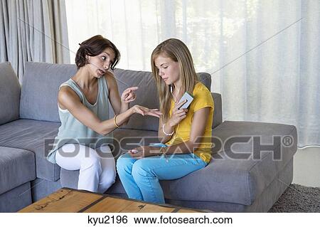 Stock Photograph - Woman scolding her daughter. Fotosearch
