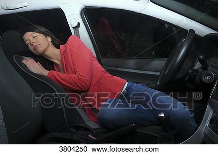 Woman sleeping at night in her car View Large Photo Image Stock Image - Woman sleeping at night in her car. Fotosearch