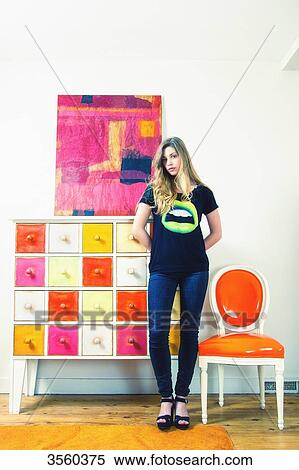 Woman standing in a colorful room View Large Photo Image Stock Photography - Woman standing in a colorful room. Fotosearch