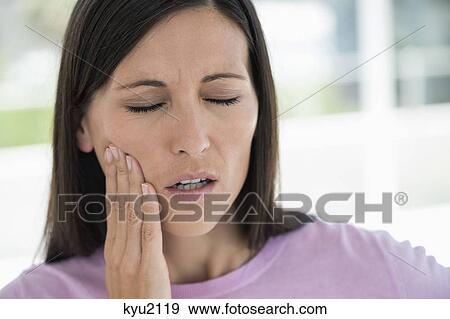 Stock Photo - Woman suffering from a toothache. Fotosearch