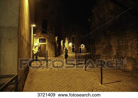 Woman walking in rome street at night, Rome, Lazio, Italy View Large Photo Image Stock Photo - Woman walking in rome street at night, Rome, Lazio, Italy. Fotosearch