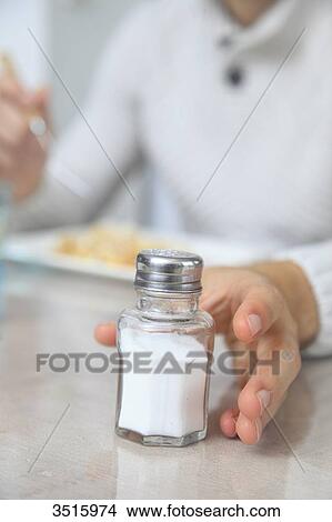 Woman with saltshaker View Large Photo Image Picture - Woman with saltshaker. Fotosearch