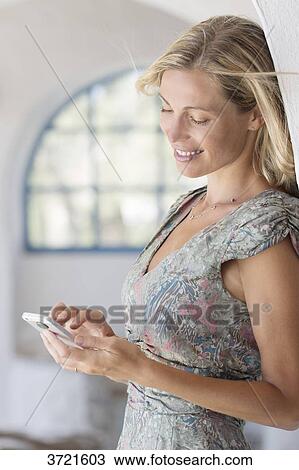 Woman writing on his phone View Large Photo Image Stock Image - Woman writing on his phone. Fotosearch