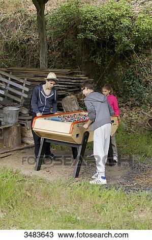 Young boys playing table football View Large Photo Image Stock Image - Young boys playing table football. Fotosearch