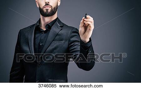 Young businessman holding a pen in his hand View Large Photo Image Stock Photography - Young businessman holding a pen in his hand. Fotosearch
