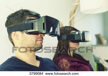 Picture - Young couple at home using virtual mask. Fotosearch