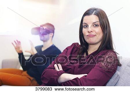 Stock Image - Young couple at home using virtual mask. Fotosearch