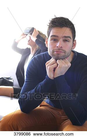 Young couple at home using virtual mask View Large Photo Image Stock Photograph - Young couple at home using virtual mask. Fotosearch