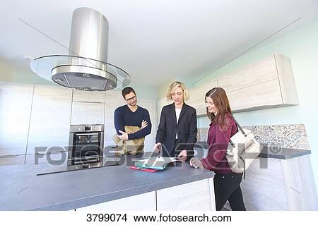 Young couple with estate agent. View Large Photo Image Picture - Young couple with estate agent.. Fotosearch