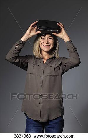 Young female with virtual reality mask View Large Photo Image Stock Image - Young female with virtual reality mask. Fotosearch