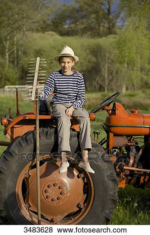 Young girl on a old tractor View Large Photo Image Stock Photo - Young girl on a old tractor. Fotosearch