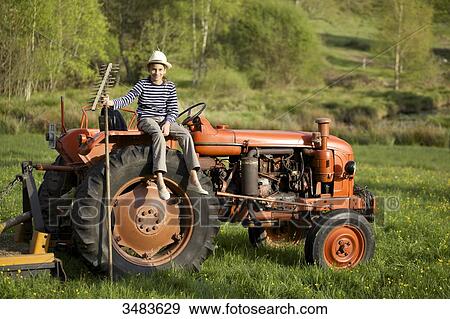 Young girl on an old tractor View Large Photo Image Stock Photo - Young girl on an old tractor. Fotosearch