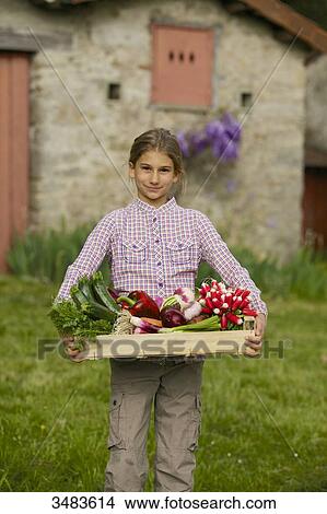 Young girl with vegetables from the garden View Large Photo Image Picture - Young girl with vegetables from the garden. Fotosearch