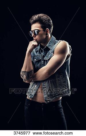 Young man in jeans jacket, profile, hand under chin View Large Photo Image Stock Photo - Young man in jeans jacket, profile, hand under chin. Fotosearch