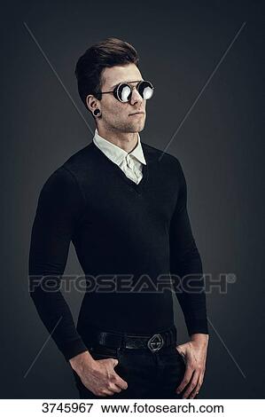 Young man with sunglasses, hands in pockets View Large Photo Image Stock Photo - Young man with sunglasses, hands in pockets. Fotosearch