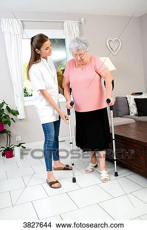 Young physiotherapist nurse helping elderly women physical rehabilitation at home View Large Photo Image Picture - Young physiotherapist nurse helping elderly women physical rehabilitation at home. Fotosearch