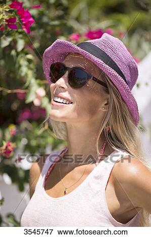 Young smiling woman with a sunhat View Large Photo Image Stock Photo - Young smiling woman with a sunhat. Fotosearch