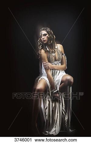 Young tribal woman sitting wearing a beige dress - Fashion Design Sanhadja View Large Photo Image Stock Image - Young tribal woman sitting wearing a beige dress - Fashion Design Sanhadja. Fotosearch