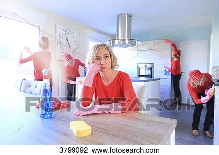 Stock Image - Young woman at home sitting at the table.. Fotosearch