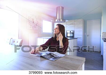Young woman at home sitting at the table. View Large Photo Image Stock Image - Young woman at home sitting at the table.. Fotosearch