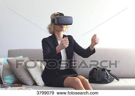 Young woman at home using virtual mask View Large Photo Image Stock Photo - Young woman at home using virtual mask. Fotosearch