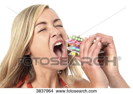 Young woman eating medicines View Large Photo Image Picture - Young woman eating medicines. Fotosearch