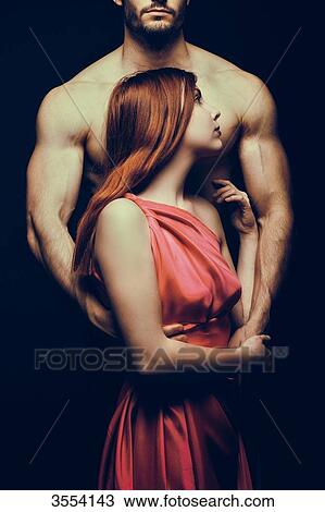 Young woman embraced by a man View Large Photo Image Stock Image - Young woman embraced by a man. Fotosearch