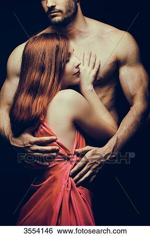 Young woman embraced by a man View Large Photo Image Stock Photograph - Young woman embraced by a man. Fotosearch