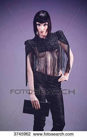 Young woman, face, hand on hip, wearing trousers and a high Bolongaro Trevor View Large Photo Image Stock Image - Young woman, face, hand on hip, wearing trousers and a high Bolongaro Trevor. Fotosearch