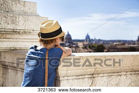 Young woman from behind, leaning on a low wall, and the city of Rome View Large Photo Image Stock Image - Young woman from behind, leaning on a low wall, and the city of Rome. Fotosearch