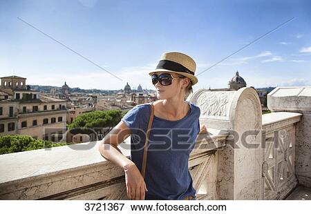 Young woman from behind, leaning on a low wall, and the city of Rome View Large Photo Image Stock Photo - Young woman from behind, leaning on a low wall, and the city of Rome. Fotosearch