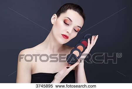 Young woman has an assortment of blusher View Large Photo Image Stock Photography - Young woman has an assortment of blusher. Fotosearch