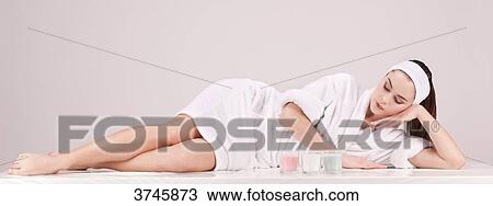 Young woman in a bathrobe, down, look down View Large Photo Image Stock Image - Young woman in a bathrobe, down, look down. Fotosearch