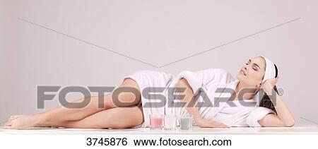 Young woman in a bathrobe, down, look up, eyes closed View Large Photo Image Stock Photograph - Young woman in a bathrobe, down, look up, eyes closed. Fotosearch
