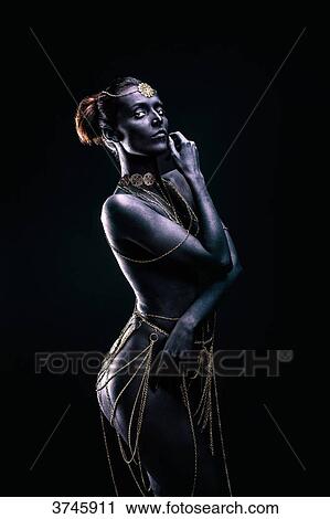 Young woman in light of ethnic ceremony, Length, Profile, a hand near the face, look at the objective View Large Photo Image Stock Image - Young woman in light of ethnic ceremony, Length, Profile, a hand near the face, look at the objective. Fotosearch