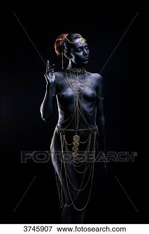 Young woman in light of ethnic ceremony, Length, Front, a show of hands, look to the side View Large Photo Image Stock Photo - Young woman in light of ethnic ceremony, Length, Front, a show of hands, look to the side. Fotosearch
