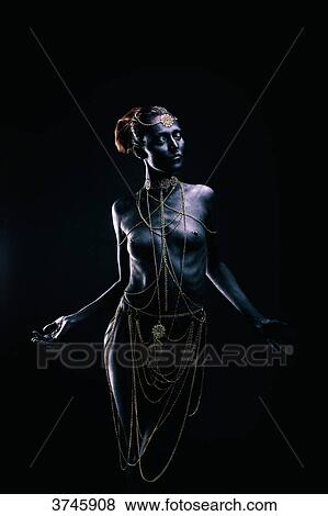 Young woman in light of ethnic ceremony, Length, face, hands on the sides, looking down View Large Photo Image Stock Photo - Young woman in light of ethnic ceremony, Length, face, hands on the sides, looking down. Fotosearch
