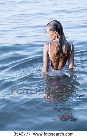Stock Photo - Young woman in the sea. Fotosearch