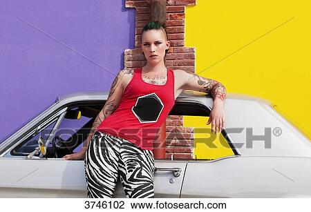 Young woman leaning on the roof of a Ford Mustang View Large Photo Image Stock Image - Young woman leaning on the roof of a Ford Mustang. Fotosearch