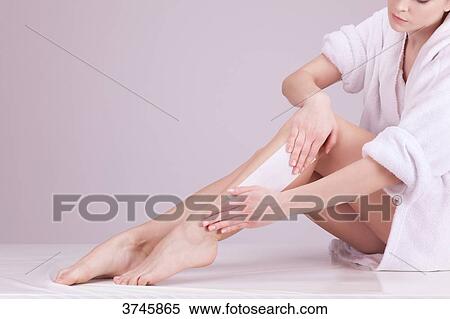 Young woman plucking her legs View Large Photo Image Stock Photography - Young woman plucking her legs. Fotosearch