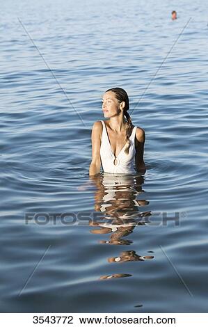Young woman sitting in the sea View Large Photo Image Stock Image - Young woman sitting in the sea. Fotosearch