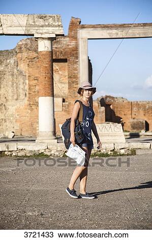 Young woman, tourist, walking in front of the ruins of Pompeii View Large Photo Image Stock Image - Young woman, tourist, walking in front of the ruins of Pompeii. Fotosearch
